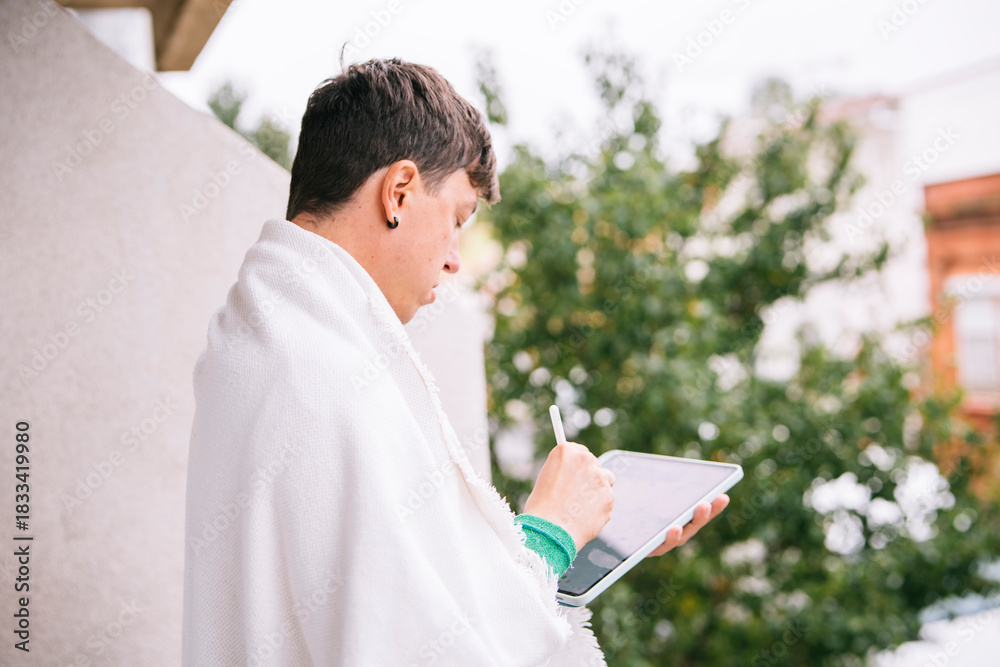 Obraz premium Young Caucasian man creating architectural sketches outdoors with stylus