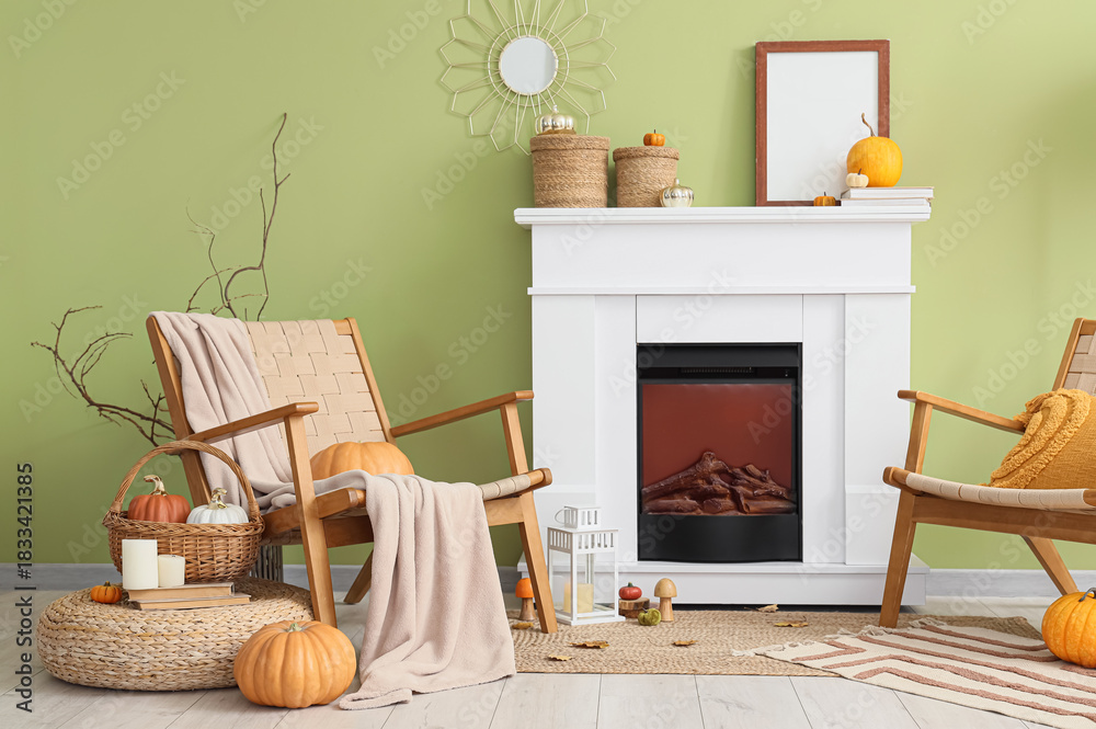 Fototapeta premium Interior of room with fireplace, pumpkins and armchairs