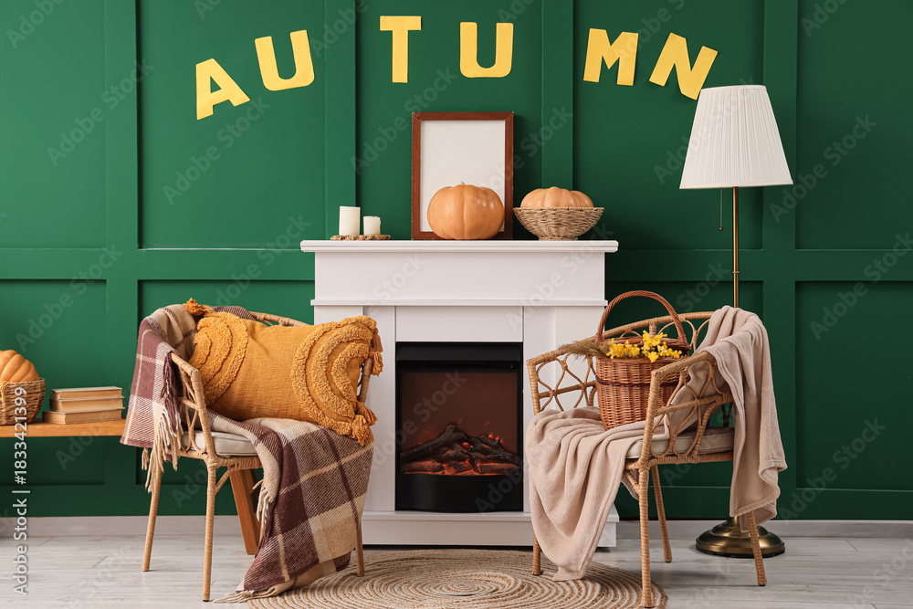 Fototapeta premium Interior of room with autumn decor, fireplace and armchairs