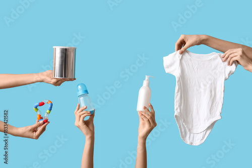Many female hands with baby...