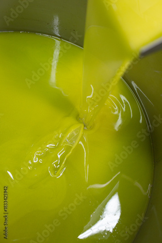 Golden Extra Virgin Olive Oil Pouring from a Traditional Press in a Local Mill