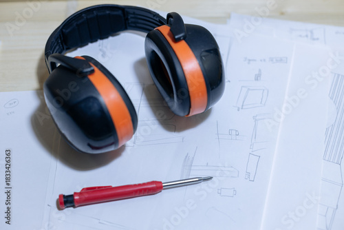 A young craftsman restores a caravan in a hangar.