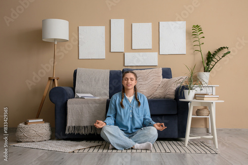 Young woman meditating on f...