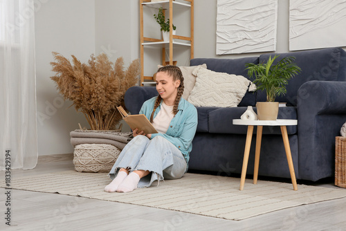 Young woman reading book an...