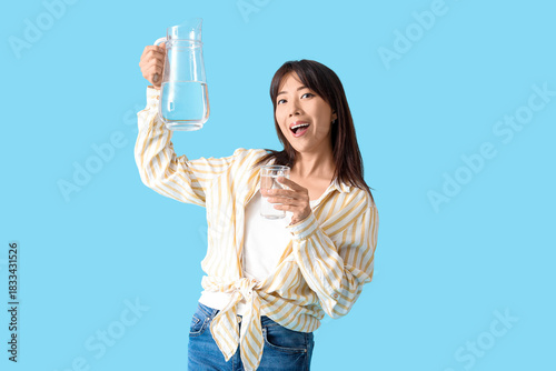 Young Asian woman with jug ...