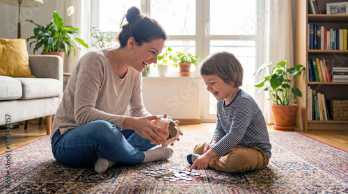 Mother and child playing with piggy bank on carpet at home