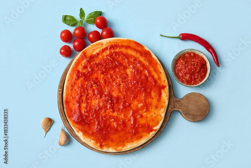 Uncooked pizza dough with t...