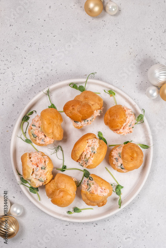 Smoked Salmon Cream Puffs served on a round plate with festive decorations