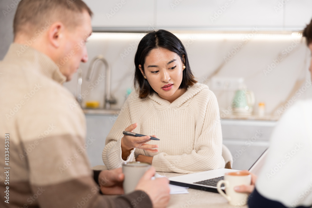 Fototapeta premium Female realtor tells two men the terms of a rental agreement