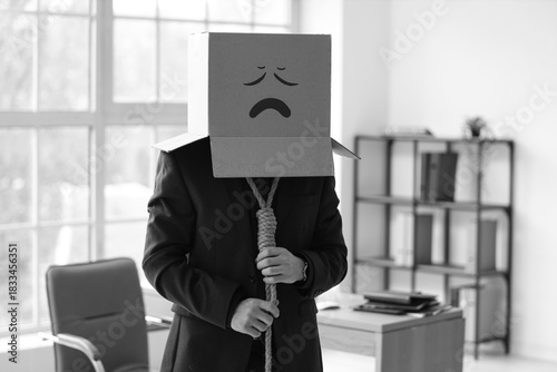 Businessman in cardboard bo...