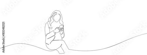 A woman is sitting and using a smartphone in one continuous line. single line art style vector illustration. Editable stroke.