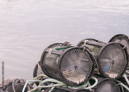 Stack of crab and lobster pots on a dock near the water