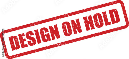 Distressed rectangular rubber stamp with DESIGN ON HOLD text, conveying a temporary pause or pending status