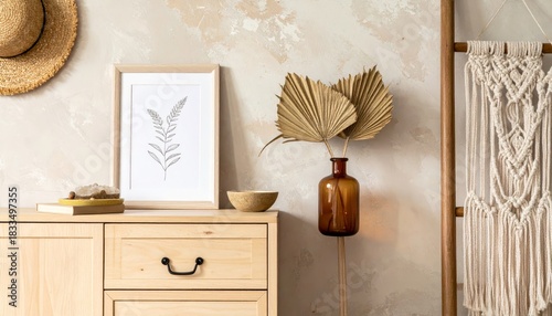 Stylish boho interior of living room with brown mock up poster frame, elegant accessories, flowers in vase, wooden shelf and hanging rattan hut. Minimalistic concept of home decor. Template