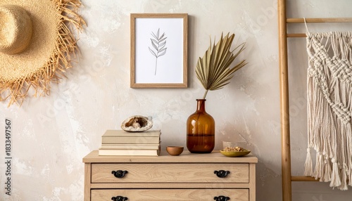 Stylish boho interior of living room with brown mock up poster frame, elegant accessories, flowers in vase, wooden shelf and hanging rattan hut. Minimalistic concept of home decor. Template