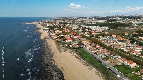 Espinho, Portugal - 12.10.2025: Aerial drone video flying over the coastal town of Espinho, Portugal, showing beautiful beaches, ocean waves, and red-roofed houses.