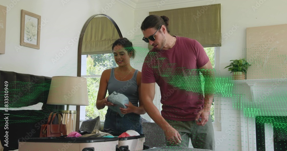 Fototapeta premium Packing couple in living room over open suitcase, woman in tank, jeans, man shades, green overlay