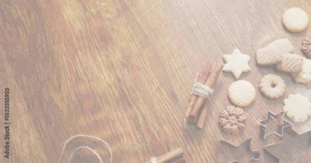 Fototapeta Styling star, round cookies with metal cutters, cinnamon sticks, twine on wood table, copy space