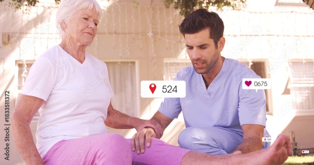 Obraz premium Kneeling caregiver in scrubs examining senior woman lower leg on porch, with icons
