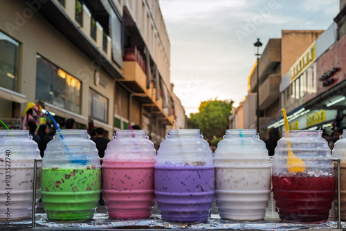 Aguas frescas – Traditional fruit drinks in large containers at street stall in Guadalajara, Mexico