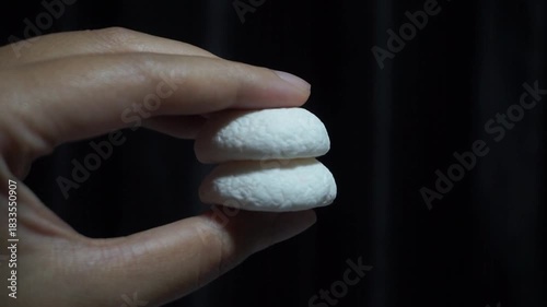 Squeezing Soft White Marshmallows Between Fingers