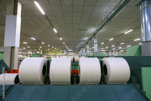 A close-up of a spool of yarn inside the factory