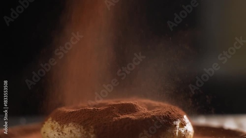 Slow motion dusting of cocoa powder over a pastry