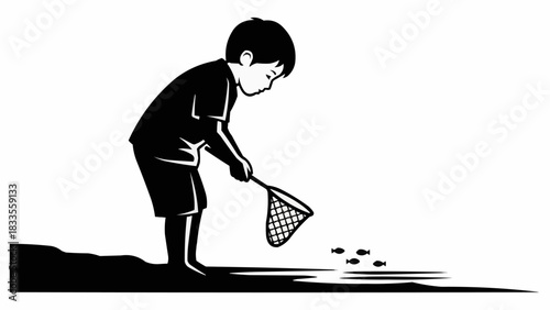 Young boy with a net exploring shallow water for small creatures.