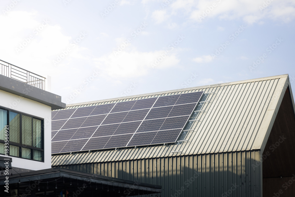 Fototapeta premium Solar Panels on Metal Roof Sheet, modern rooftop fitted with high-efficiency solar panels under clear sky. Clean energy setup symbolizes sustainable power and renewable energy solutions.