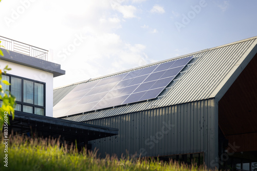 Wallpaper Mural Solar panels on metal roof sheet, installed on modern building and surrounded by green plants at evening. Rooftop solar energy system highlights clean power, renewable energy and eco-friendly. Torontodigital.ca
