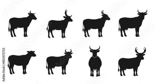 Collection of Black Silhouettes of Cows in Various Poses.