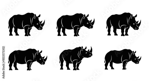 Set of Six Black Rhinoceros Silhouettes Facing Different Directions.