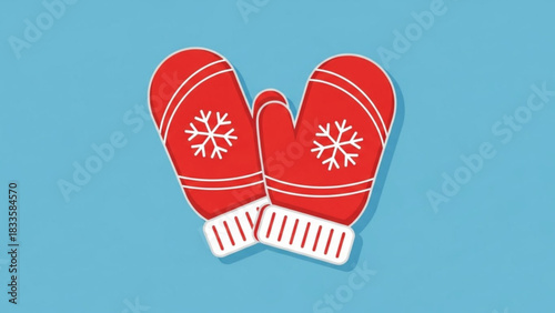 Pair of red knitted winter mittens with white snowflake designs and striped cuffs isolated on a solid blue background representing warmth and cold weather