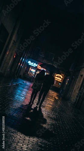 Romantic Couple Walking Under Umbrella in Rainy Night City