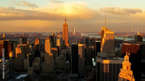 A majestic timelapse of a modern metropolitan skyline at golden hour with slow-moving clouds casting shadows over sun-reflecting windows against a colorful sky, concept of urban beauty and time passag