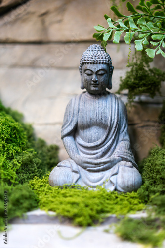 The Buddha stone statue on the stone wall