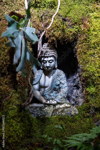 The Buddha stone statue on the stone wall