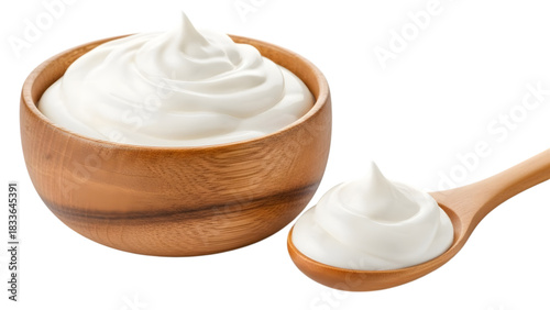 Wooden bowl and spoon with swirls of white cream isolated on transparent background