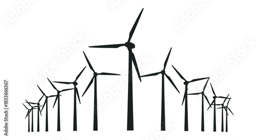 A striking view of several wind turbines standing against a bright clear sky silhouette
