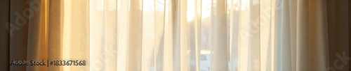 Sheer Cream Curtains Billowing in Sunlight, Creating a Soft and Airy Atmosphere in a Sunlit Room. Perfect for Adding Sophistication and Privacy to Any Interior Space.