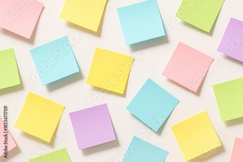 Colorful Sticky Notes Array: A visually appealing array of colorful sticky notes is scattered across a surface, representing ideas. Each note is a vibrant hue.