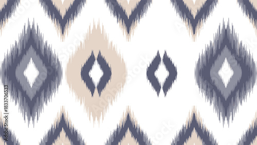 Seamless ethnic ikat pattern with abstract diamond shapes in muted blue and beige tones, creating a textured bohemian-style background.