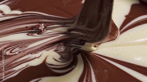 Abstract swirl of creamy white and rich brown liquid forming an elegant pattern graphic background