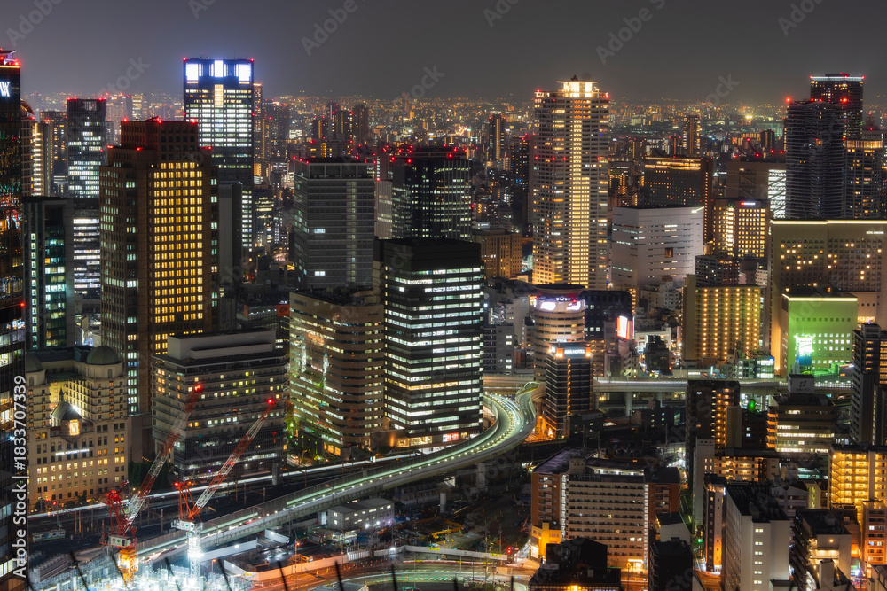 Fototapeta premium High angle view of illuminated buildings in Osaka city at night