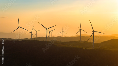 Wind farm on the mountain, blue sky and white clouds, sun at Huong Linh, Quan...