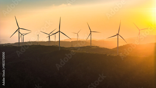 Wind farm on the mountain, blue sky and white clouds, sun at Huong Linh, Quan...