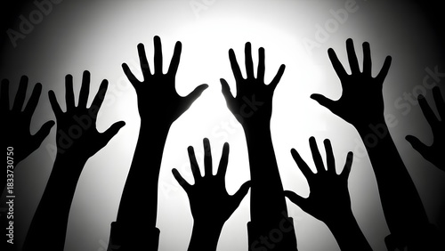 Silhouetted hands reaching upward in dark and light contrast
