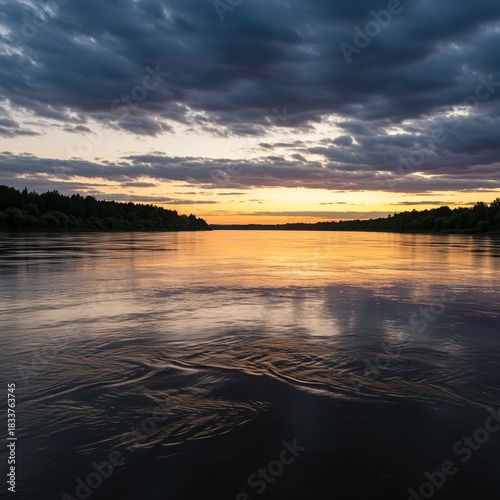 Vast river landscape at dawn, showcasing wide flowing water under a dramatic sky, reflecting tranquil natural beauty and a powerful current ,tidal ,liquid ,flowing
