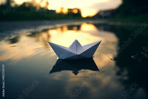 Paper boat floating on water