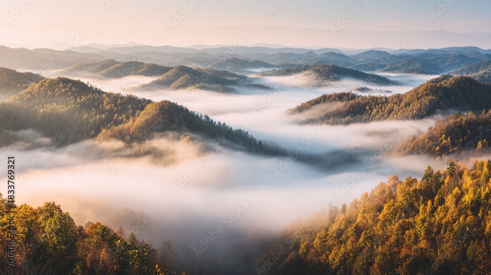 Obraz premium foothills. Misty mountainous landscape at dawn with golden light over panoramic foothills. travel magazines, destination branding, designed for outdoor magazines and nature guides.